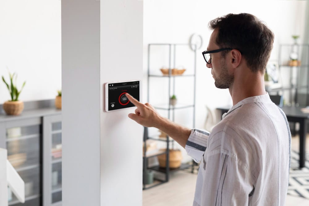 man using smart thermostat